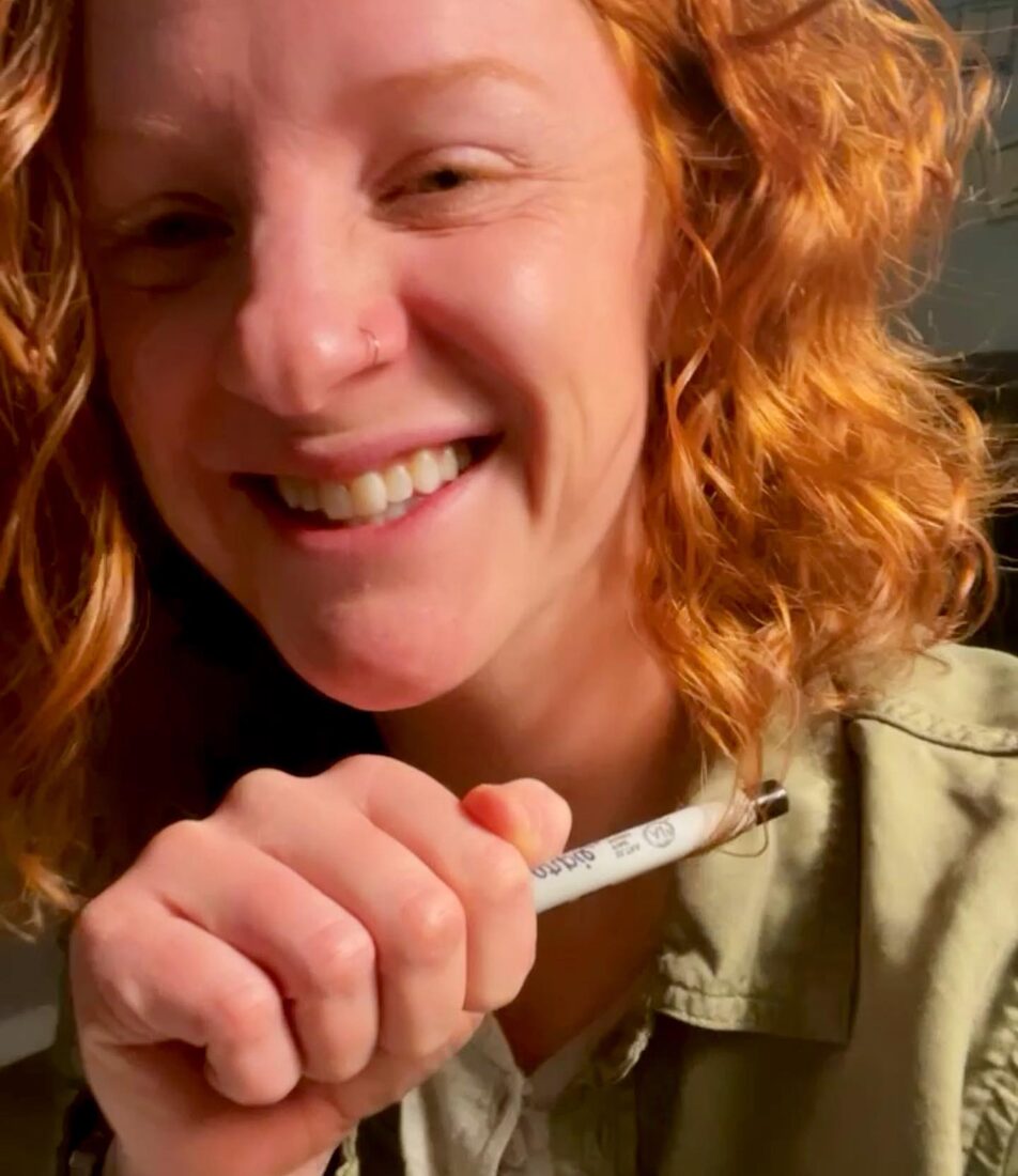 Jill Stout smiling and holding a paint pen